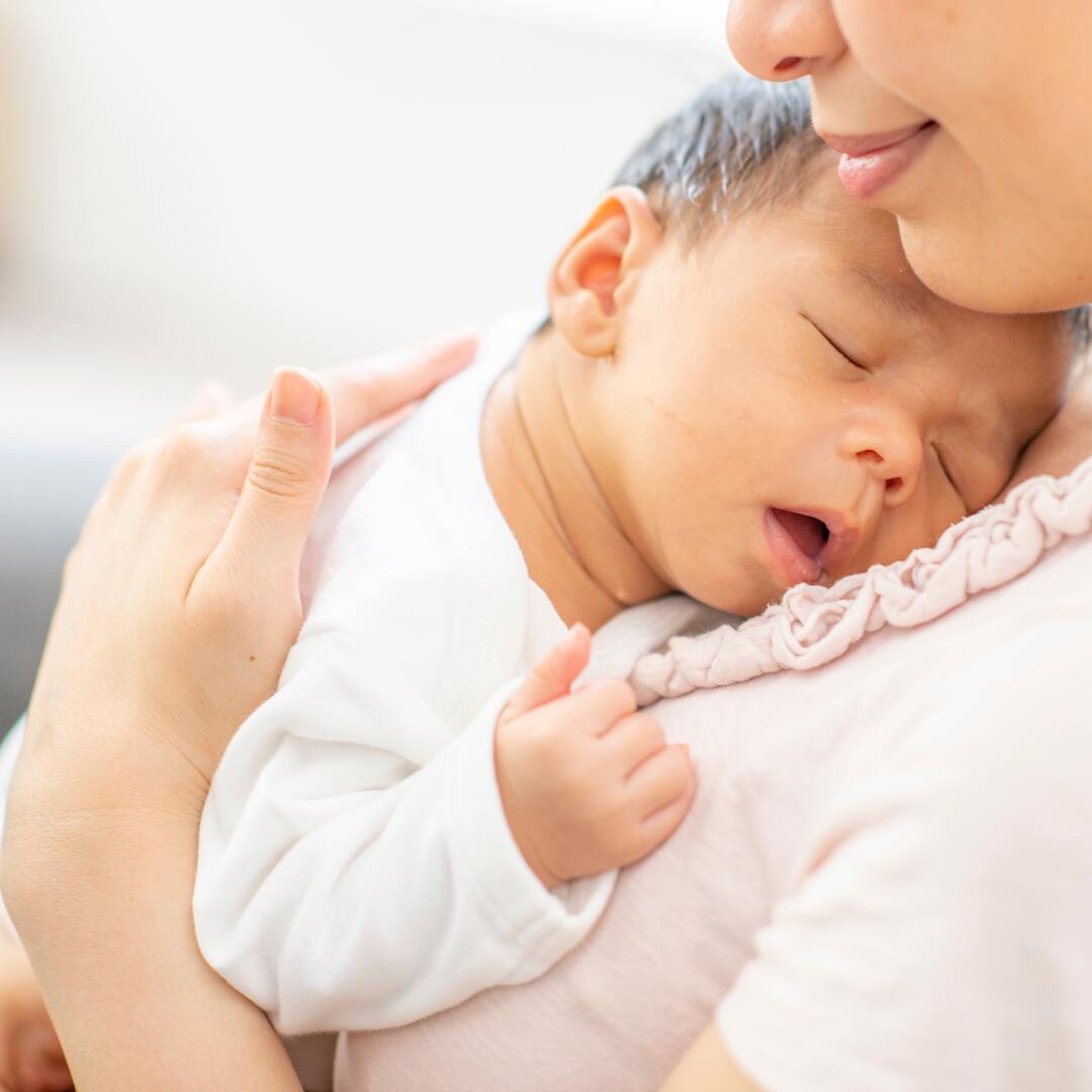 Feeling the soft cotton baby clothes